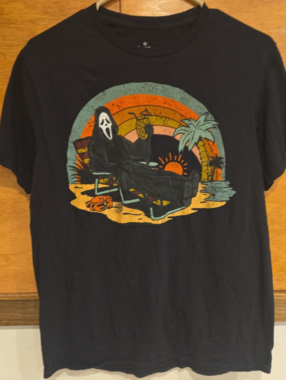 Black Graphic Tee with Tropical Ghost Face Design